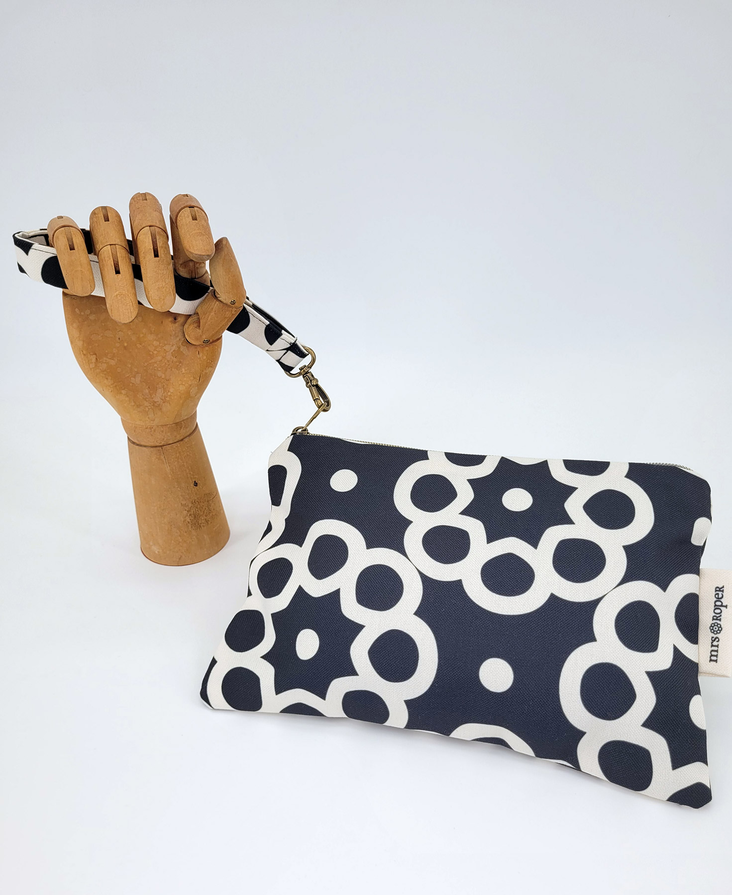 Bolso de mano con asa en tejido reciclado RPET, con estampado geométrico en negro y blanco de la marca Mrs. Roper.