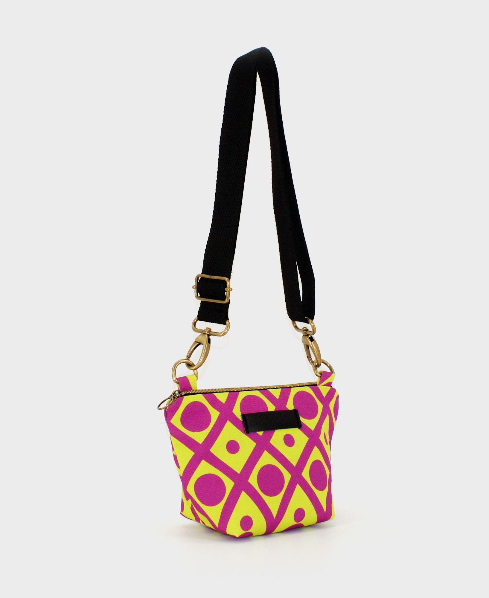 Bandolera pequeña de mujer, realizada en tejido reciclado RPET con estampado geométrico en lima y morado, de la marca Mrs. Roper.